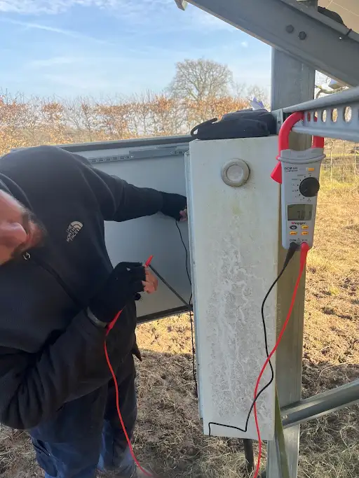 A man in a black jacket and some wires.