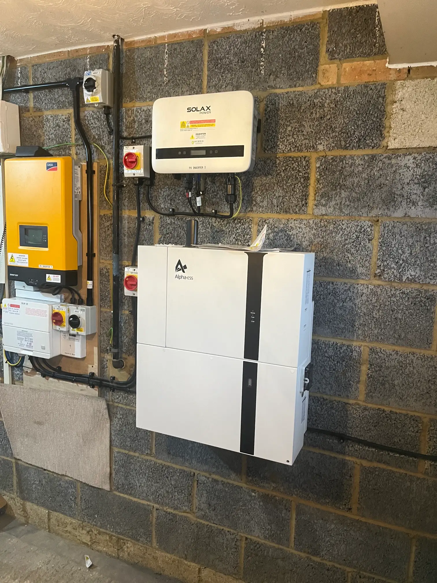 A wall with some electrical equipment attached to it.