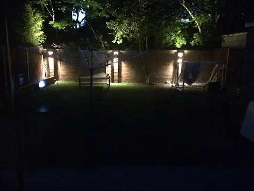 A backyard with a lot of lights on it.