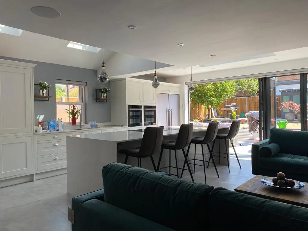 A living room with a couch a table and chairs.