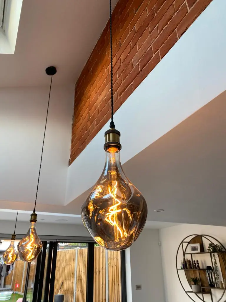 A couple of light bulbs hanging from a ceiling.